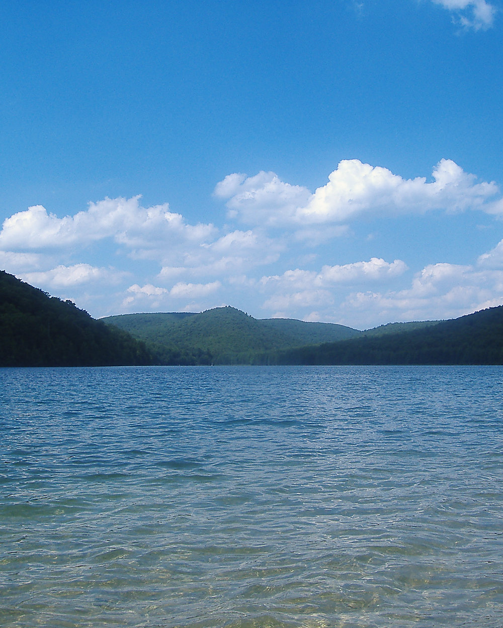 A reservoir under green ridges in Michaux State Forest, Pennsylvania